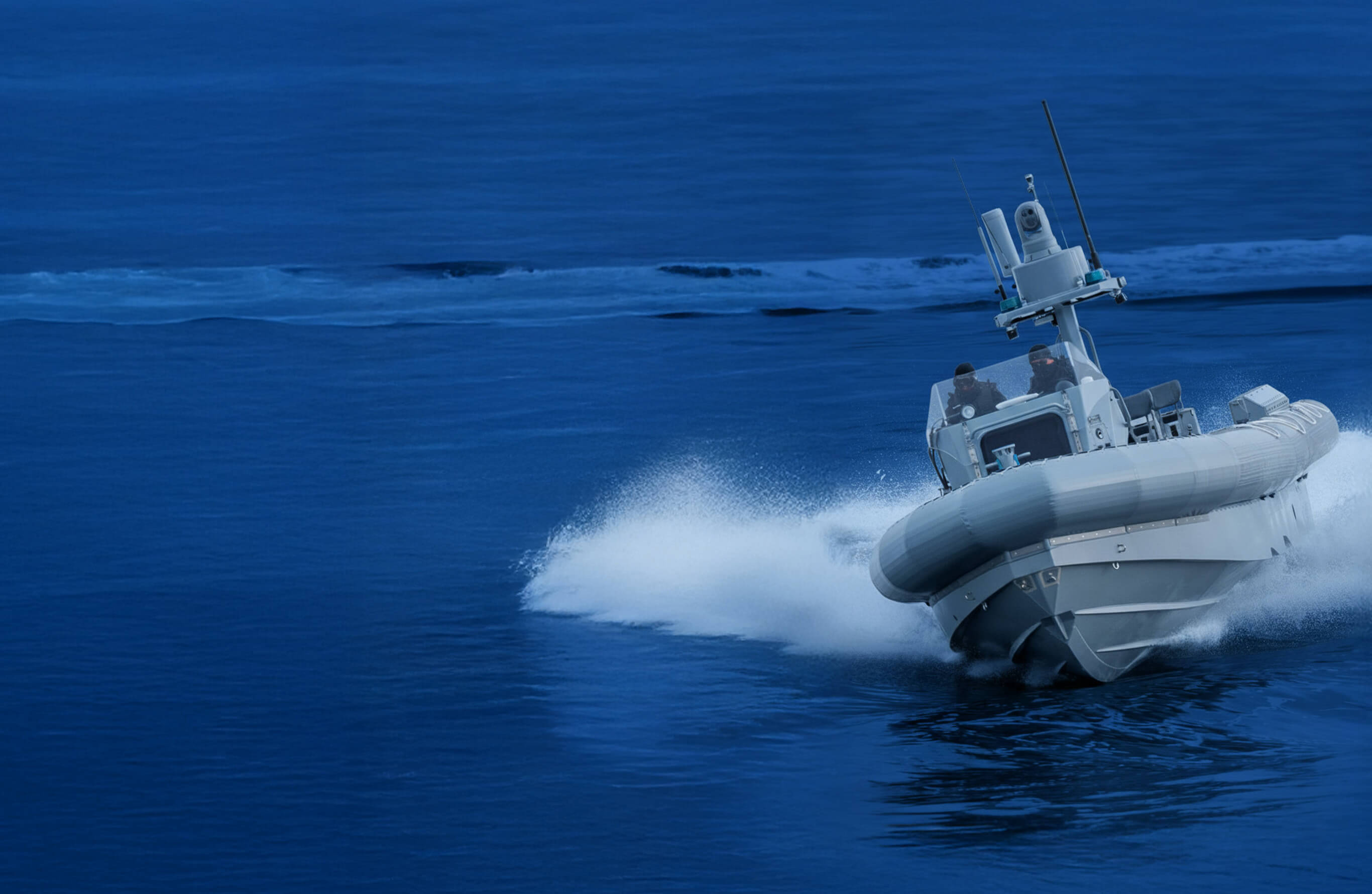 Header Image. Military Vessel sailing through calm blue waters